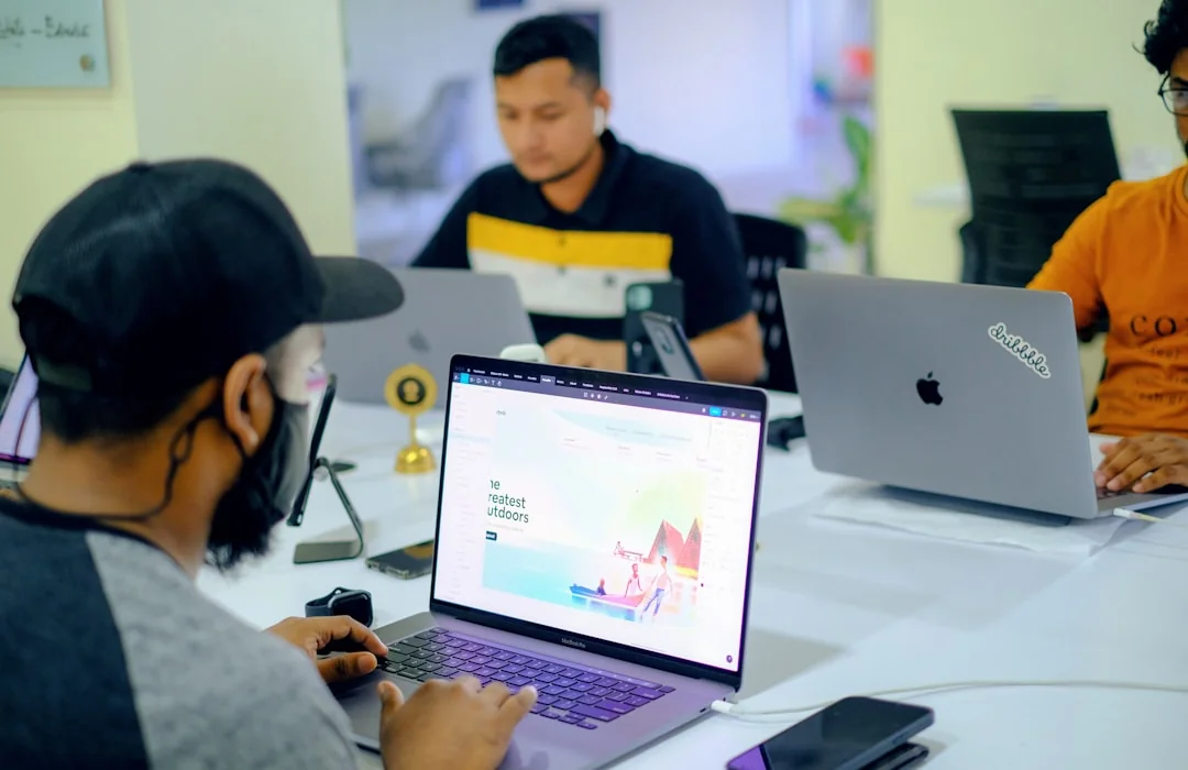 A modern workspace featuring dual computer monitors displaying web design projects, emphasizing technology and productivity.