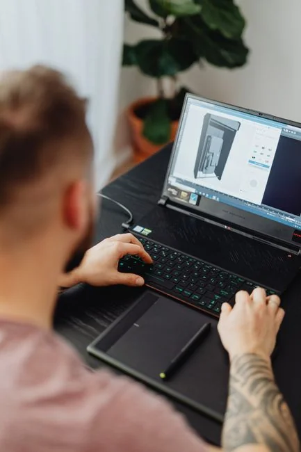 High-angle view of a stylish work desk featuring dual monitors, keyboard, mouse, and modern accessories.